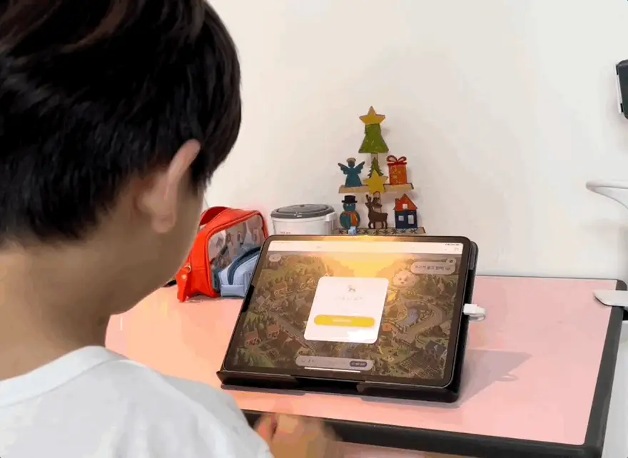 A beta-family child building an elephant story with Moongi, seen from behind